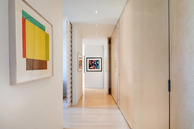 hallway with light wood finished floors and recessed lighting