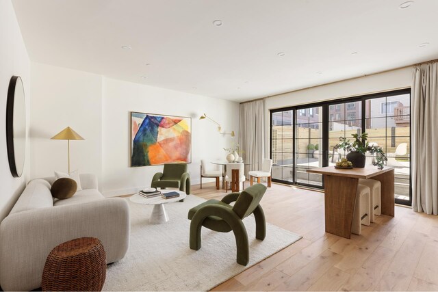 living area with baseboards and light wood-type flooring