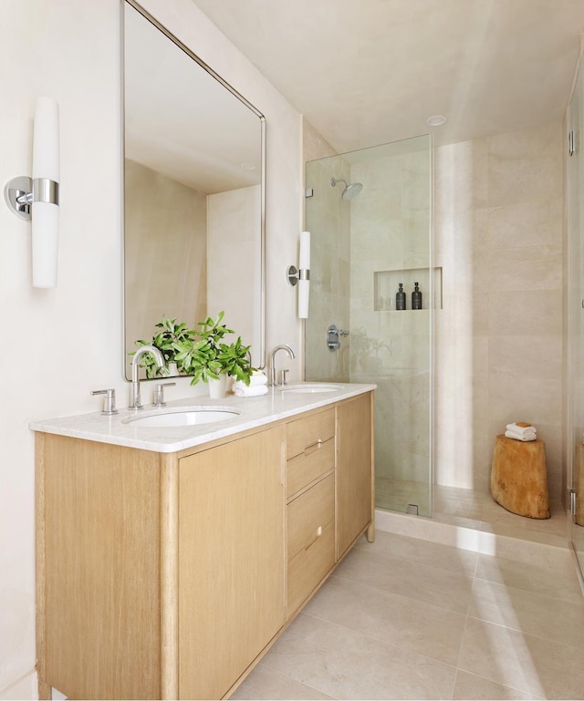 bathroom with a sink, double vanity, and a shower stall