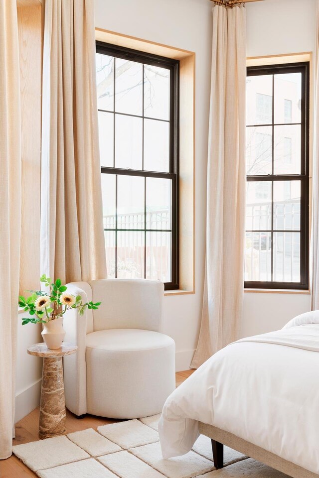 bedroom featuring baseboards and wood finished floors