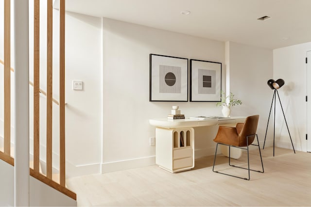 office with wood finished floors, baseboards, and visible vents