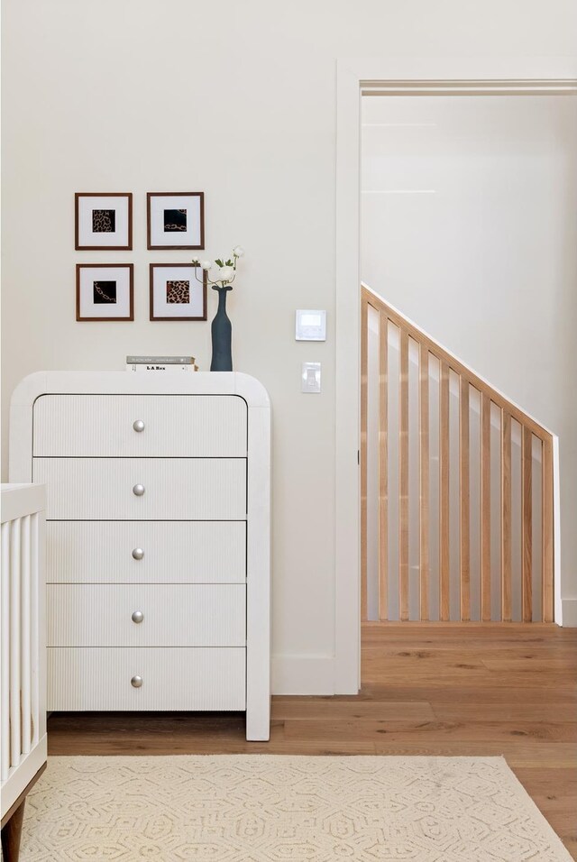 bedroom featuring baseboards and wood finished floors