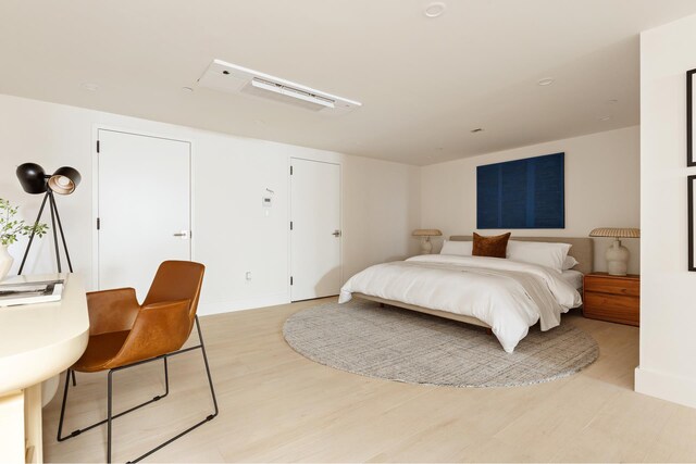 bedroom featuring baseboards and light wood-style flooring