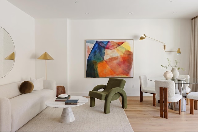 living area with recessed lighting, baseboards, and light wood finished floors