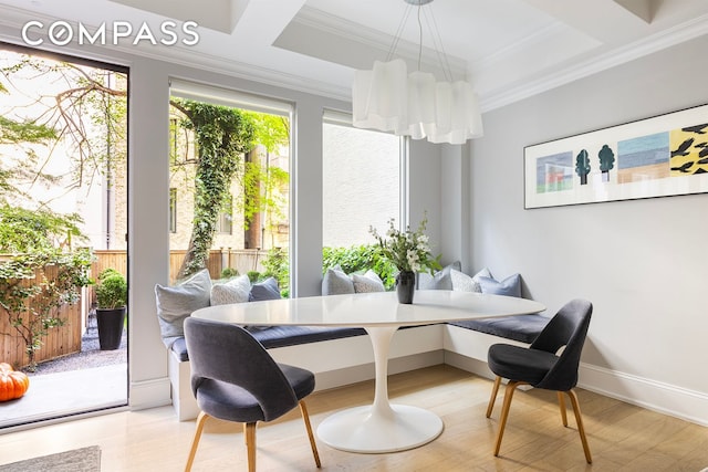 dining area with baseboards, breakfast area, wood finished floors, and ornamental molding