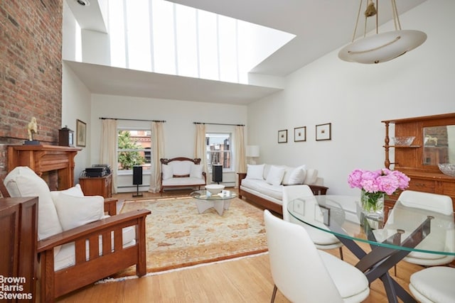 living area with a high ceiling and wood finished floors