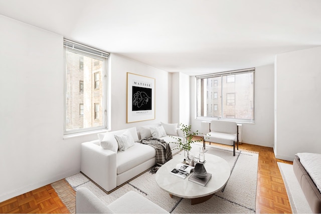 living area featuring a wealth of natural light and baseboards