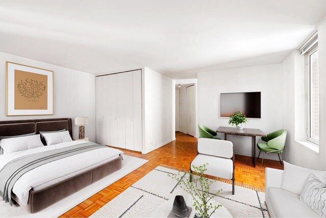 145 E 48th St Unit 8B, New York City, NY 10017 - bedroom featuring baseboards, multiple windows, and a closet