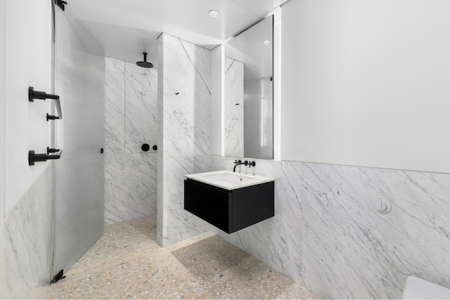 16 W 40th St Unit 21C, New York City, NY 10018 - full bath featuring a marble finish shower, vanity, tile walls, and recessed lighting