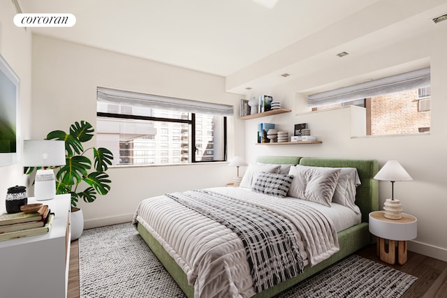 bedroom with wood finished floors and baseboards