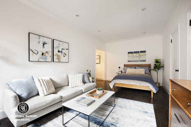 bedroom featuring dark wood-style floors and baseboards