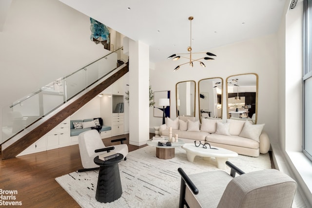 living room featuring stairway, a high ceiling, and wood finished floors