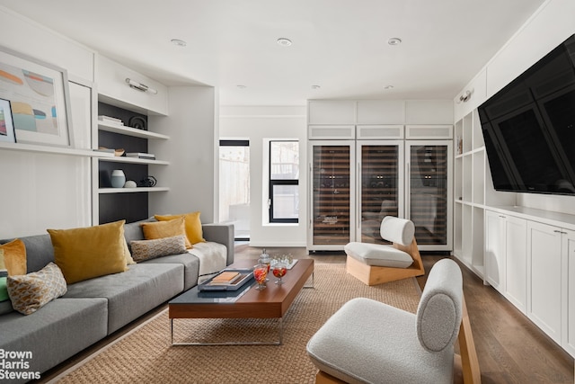 living area featuring beverage cooler and dark wood-style flooring