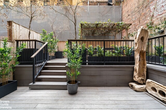 wooden terrace featuring outdoor dining area, fence, an outdoor living space, and a pergola