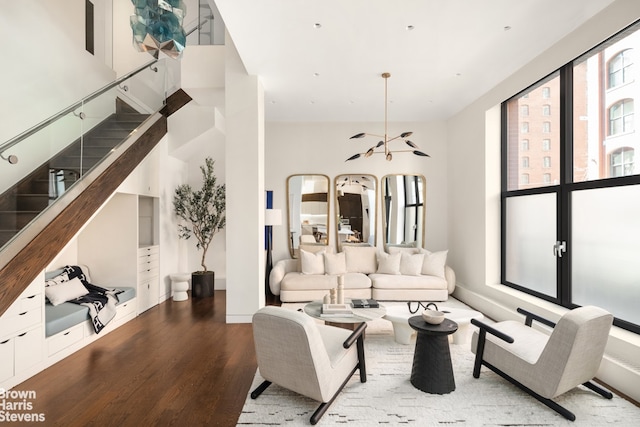 living room with stairway and wood finished floors