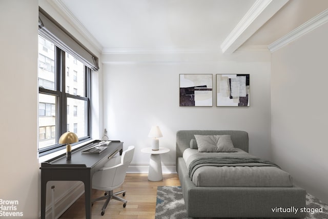 bedroom with ornamental molding and wood finished floors