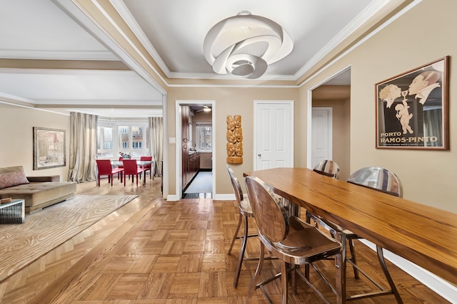 dining area featuring baseboards and crown molding