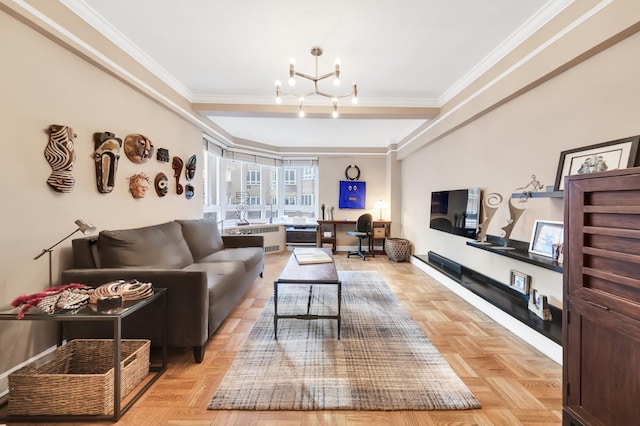 living room with radiator, a notable chandelier, crown molding, and baseboards