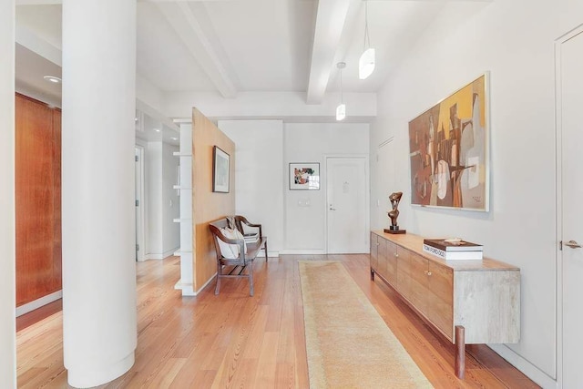 entryway featuring light wood-type flooring and beam ceiling