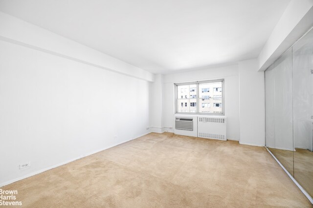interior space with radiator and carpet flooring