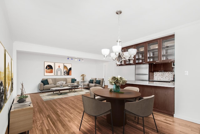 629 Kappock St Unit 4Lm, New York City, NY 10463 - dining space with a chandelier and light wood-style flooring