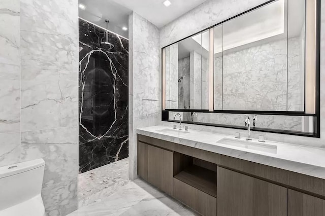 bathroom featuring a marble finish shower, marble finish floor, toilet, and a sink