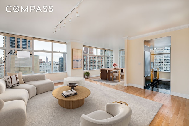 160 W 66th St Unit 23D, New York City, NY 10023 - living area with a city view, wood finished floors, rail lighting, and crown molding