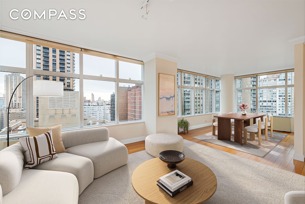 160 W 66th St Unit 23D, New York City, NY 10023 - living area featuring a view of city, wood finished floors, and plenty of natural light