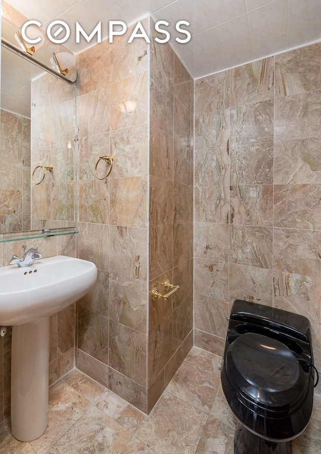 bathroom with tile walls