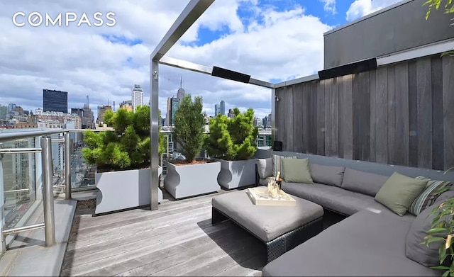 wooden deck featuring a view of city and outdoor lounge area