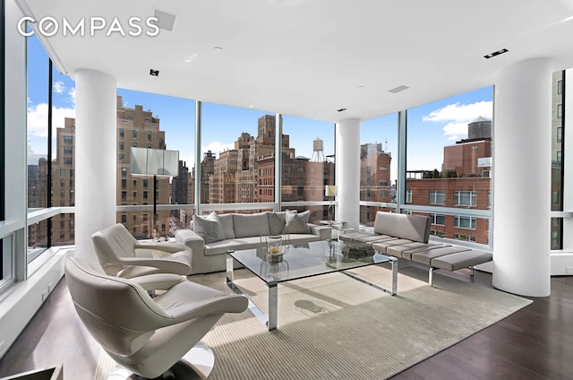 sunroom with a view of city, plenty of natural light, and visible vents