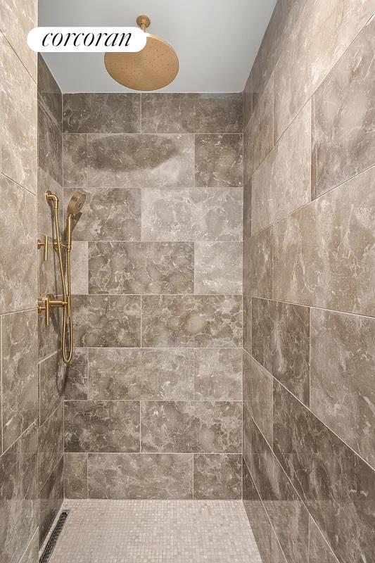 bathroom with a tile shower