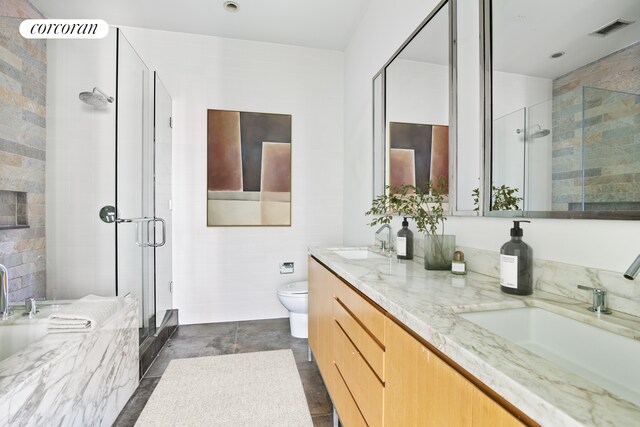 full bathroom with a stall shower, visible vents, a sink, and double vanity