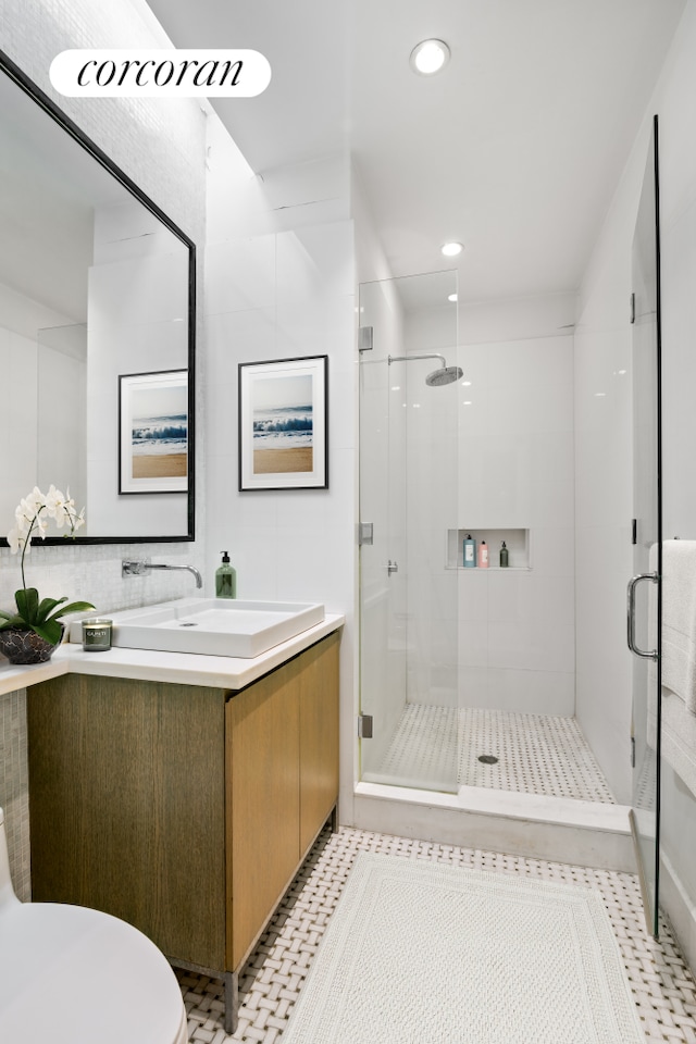 full bath with recessed lighting, toilet, vanity, a shower stall, and tile patterned floors