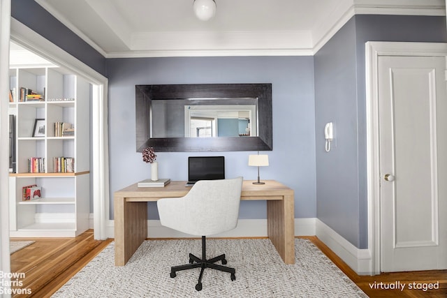 office area with baseboards, wood finished floors, and crown molding