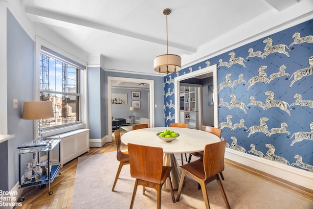 dining space with beamed ceiling and baseboards