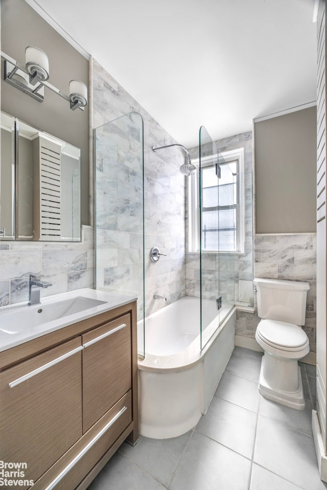 bathroom featuring tile patterned flooring, bathtub / shower combination, toilet, and tile walls