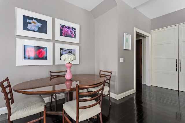 dining area with baseboards, breakfast area, and dark wood finished floors