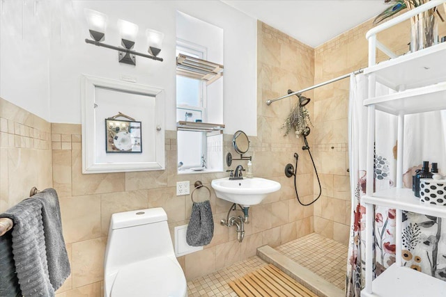 bathroom with a stall shower, toilet, tile walls, and a sink