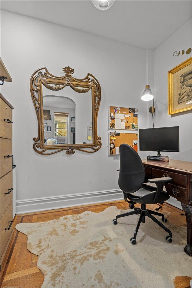 home office with wood finished floors and baseboards