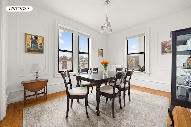 dining area featuring visible vents, baseboards, and wood finished floors