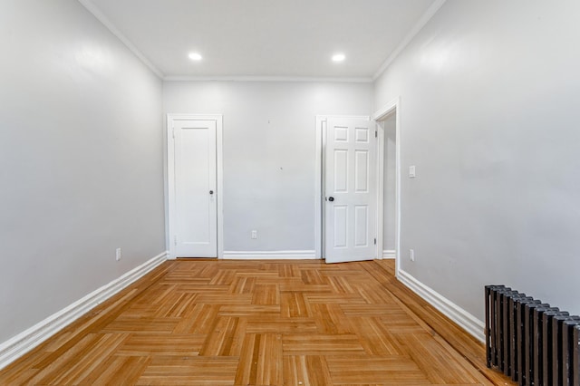 spare room featuring recessed lighting, crown molding, radiator heating unit, and baseboards