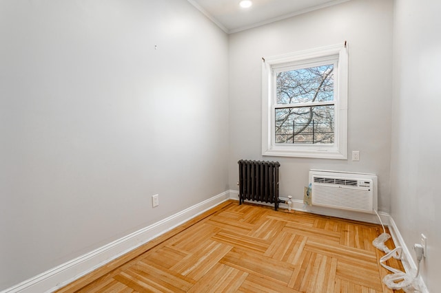 unfurnished room with an AC wall unit, radiator heating unit, recessed lighting, and baseboards