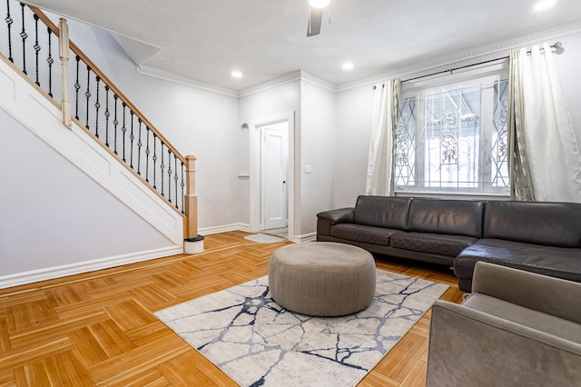 living area with recessed lighting, crown molding, baseboards, ceiling fan, and stairs