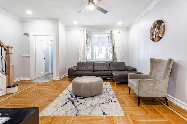 living room with stairway, a ceiling fan, crown molding, and baseboards