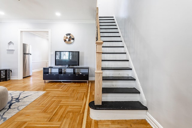 stairway featuring crown molding and baseboards