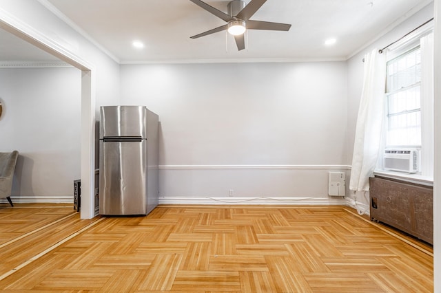 interior space featuring cooling unit, baseboards, radiator heating unit, ceiling fan, and ornamental molding