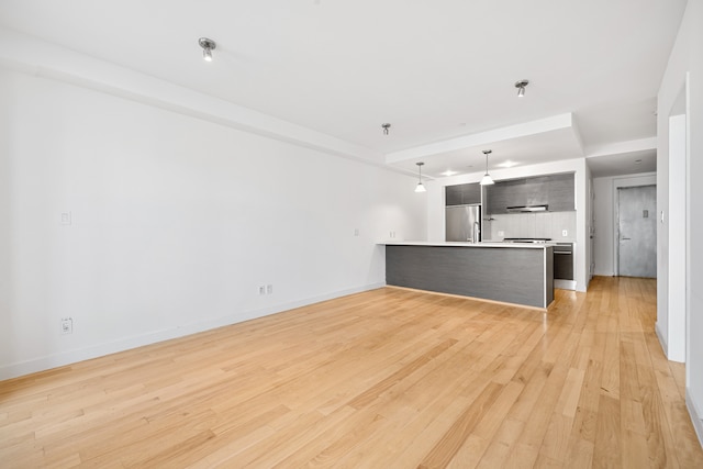 unfurnished living room featuring light wood finished floors and baseboards