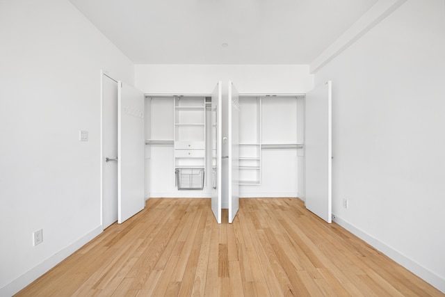 unfurnished bedroom with light wood-style floors and baseboards