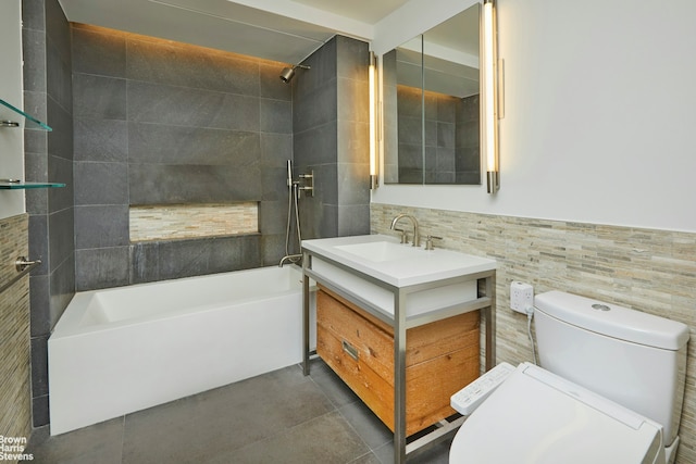 bathroom featuring tile walls, toilet, vanity, shower / washtub combination, and tile patterned flooring